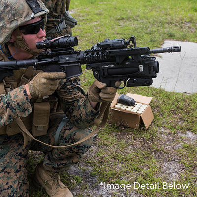 A Marine uses a Quick Release Firearm Sling on an M320 grenade launcher module mounted on an M4 rifle