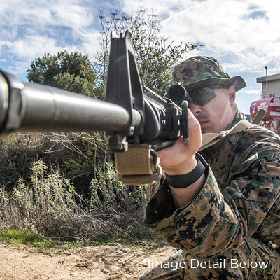 A U.S. Marine sights in on a barrel with NSN Vickers Sling mounted
