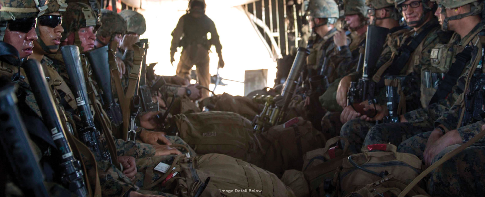 A platoon of U.S. Marines Regimentsit with their Standard Issue Vickers Sling inside of a CH-53E Super Stallion helicopter
