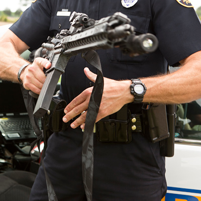 Police Officer getting out of vehicle with Kryptek Typhon Sling attached to AR 15